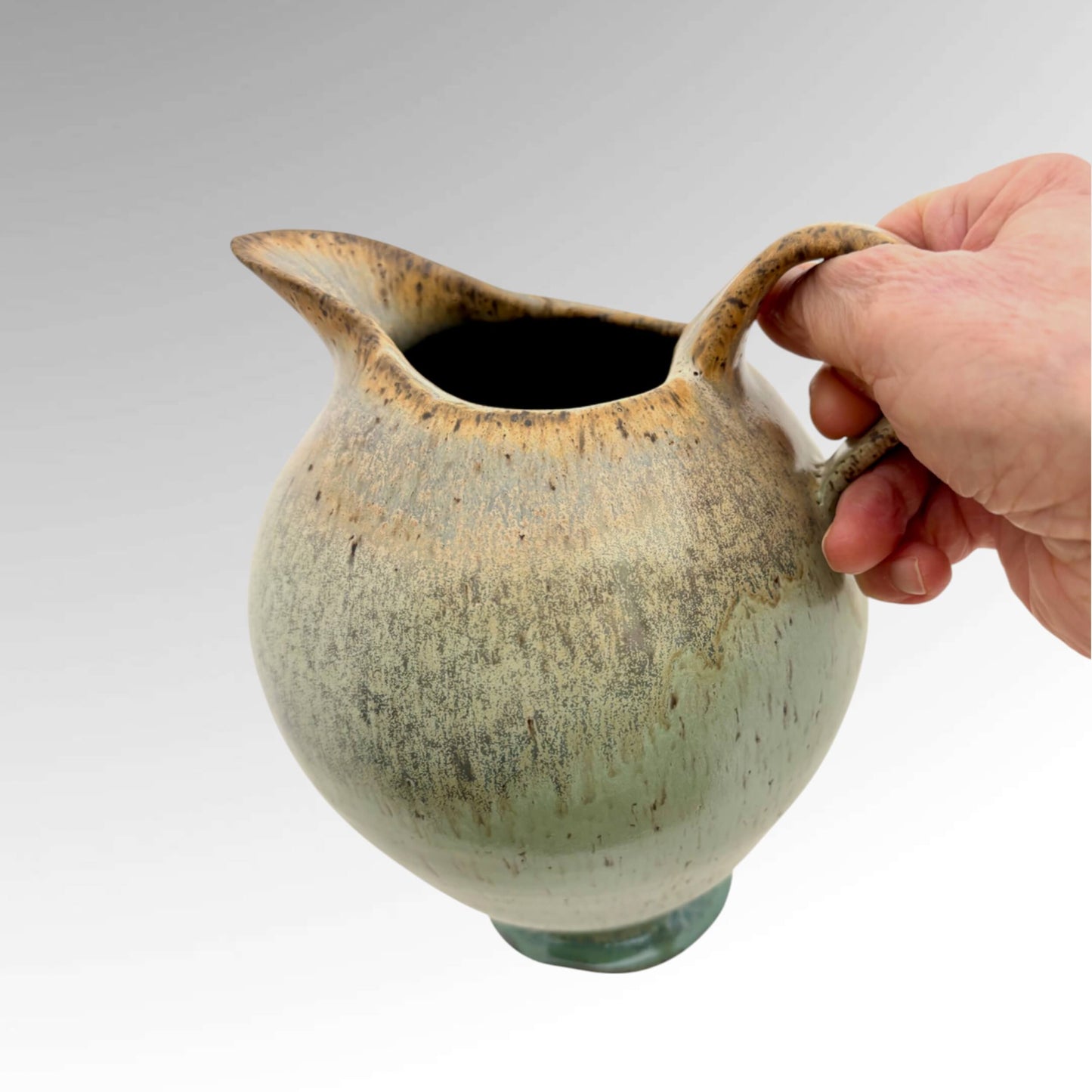 Green pitcher held in hand for scale - Judy Musicant