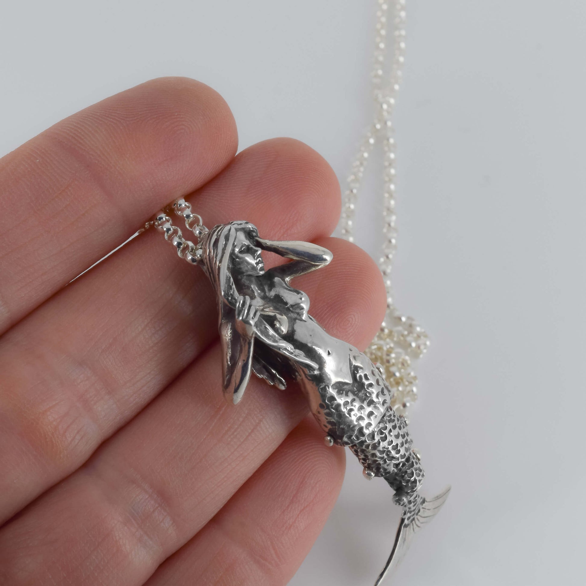 Mermaid Pendant Necklace in Sterling Silver held in hand for scale- Jane Voorhees