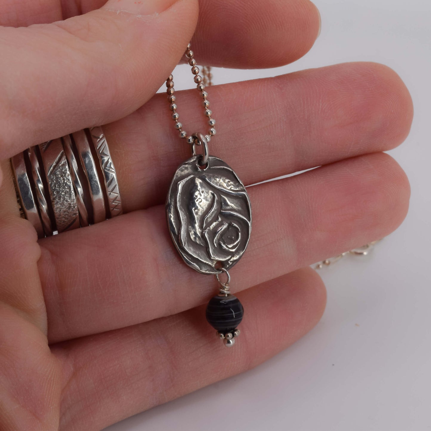 Rose Pendant Necklace with Agate shown in hand for scale - Karin White