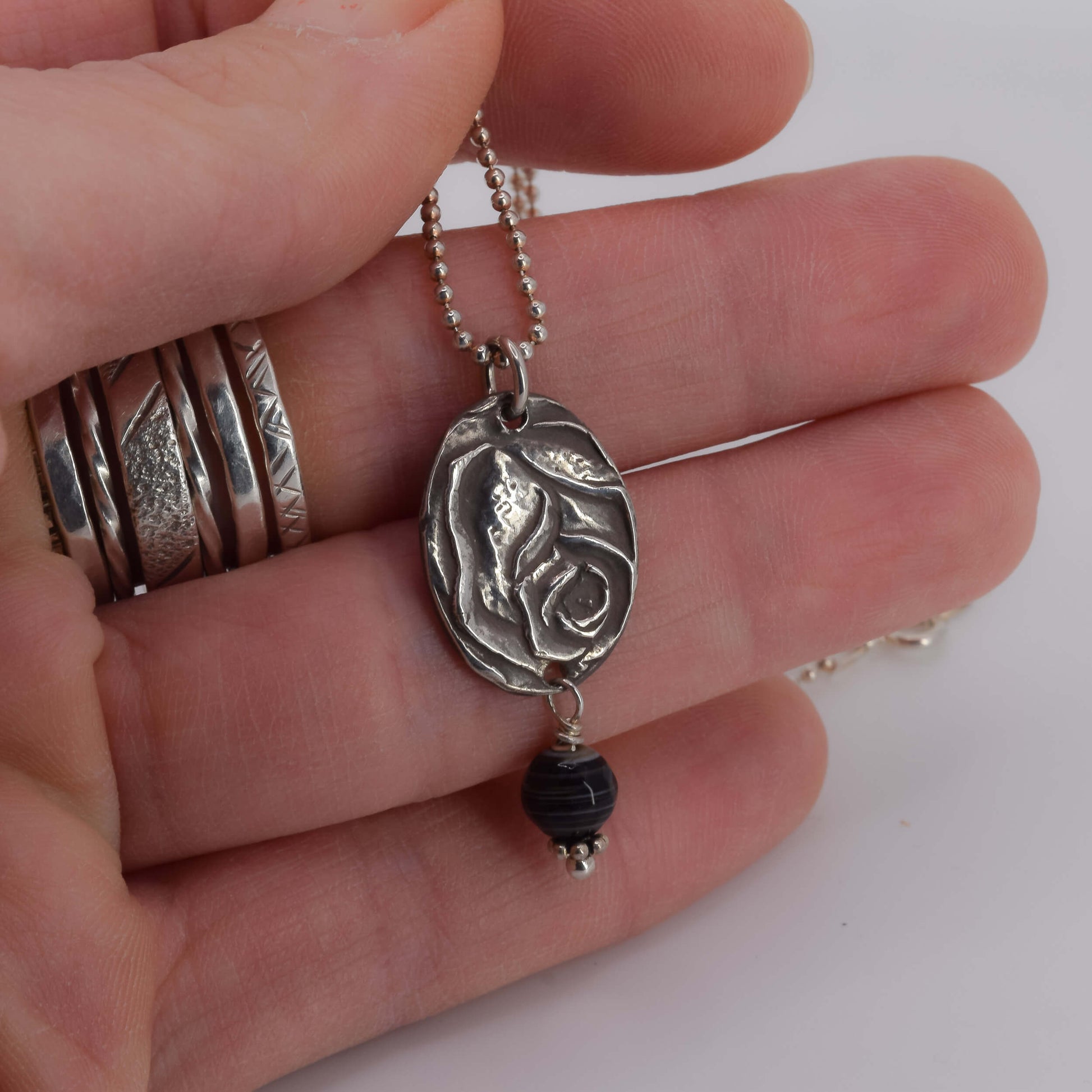 Rose Pendant Necklace with Agate shown in hand for scale - Karin White