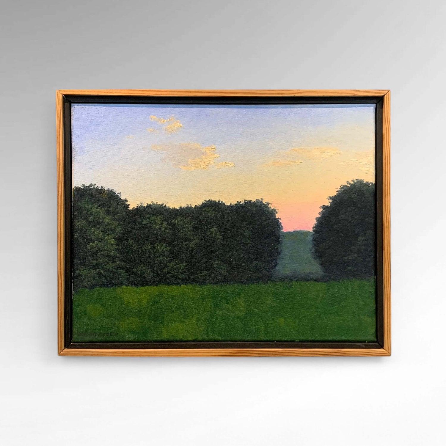 Watercolor painting of a sunset in a field with bushes on the horizon