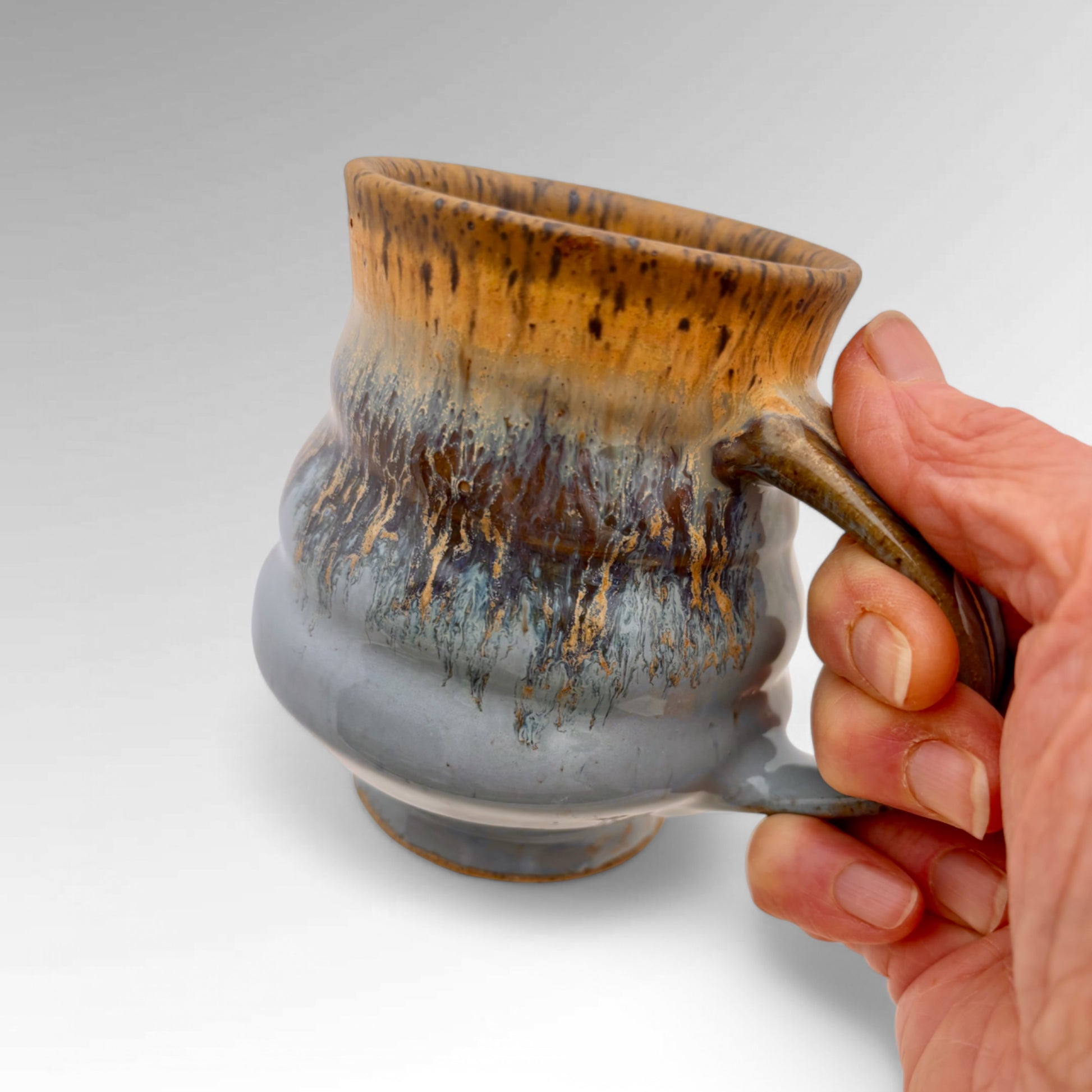 Blue mug held in hand for scale - Judy Musicant