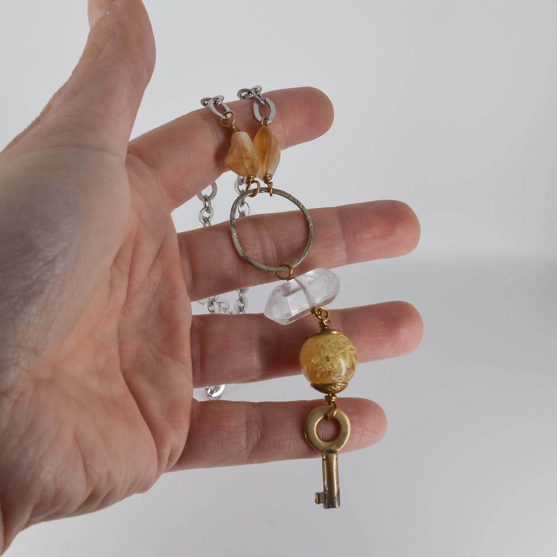 Boho Style Vintage Key Necklace held in hand for scale