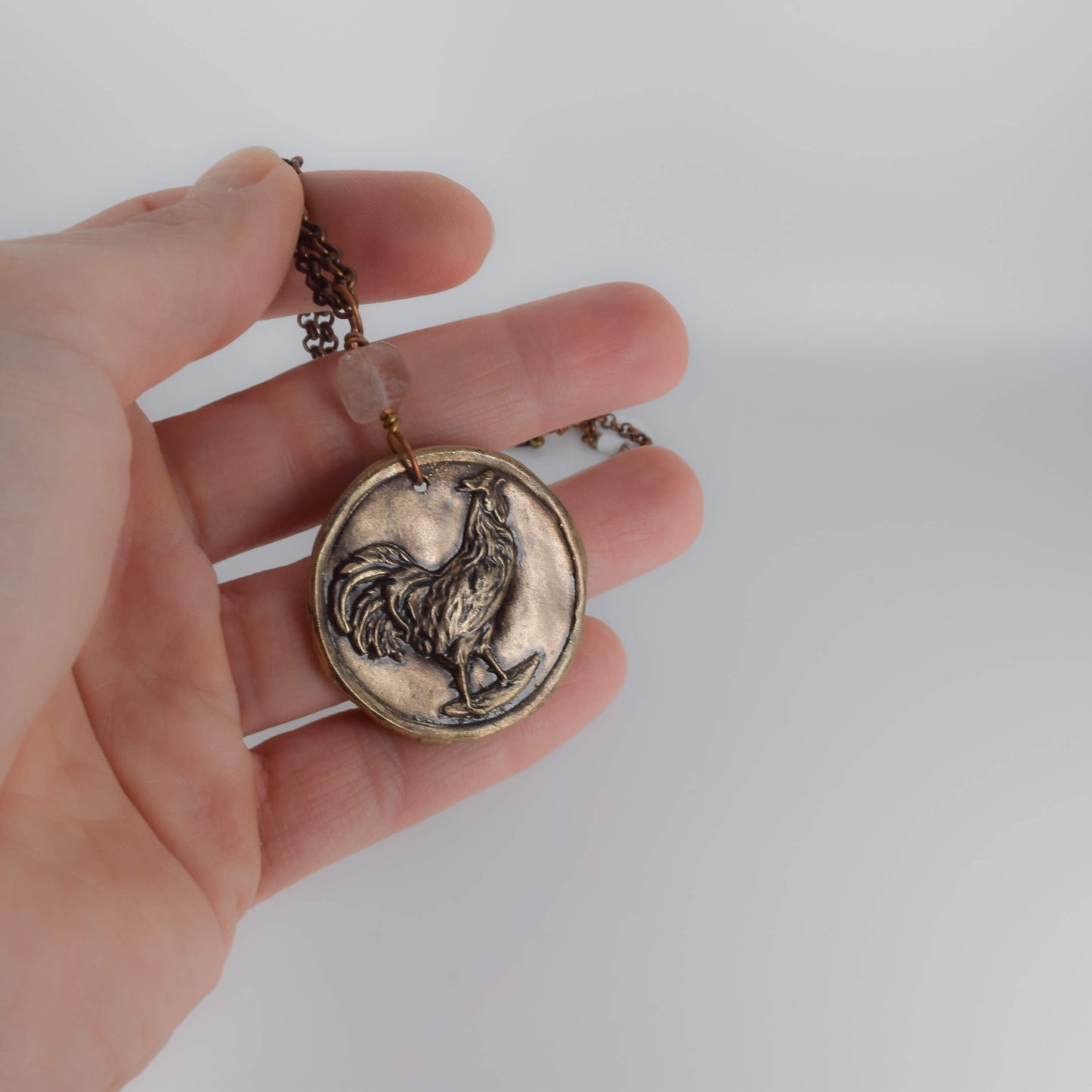 Bronze Clay Pendant Necklace - Brooke VanDerzee held in hand for scale