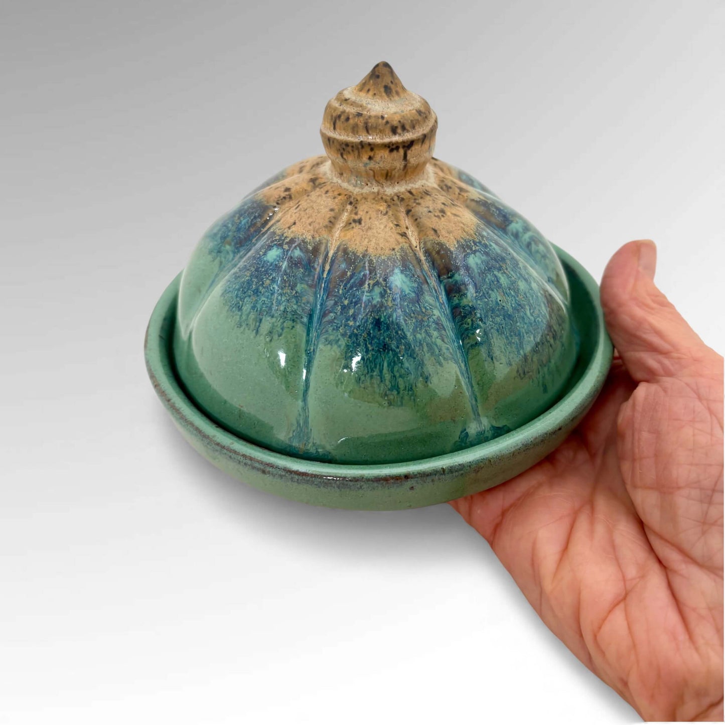 Garlic Roaster Judy Musicant shown in hand for scale