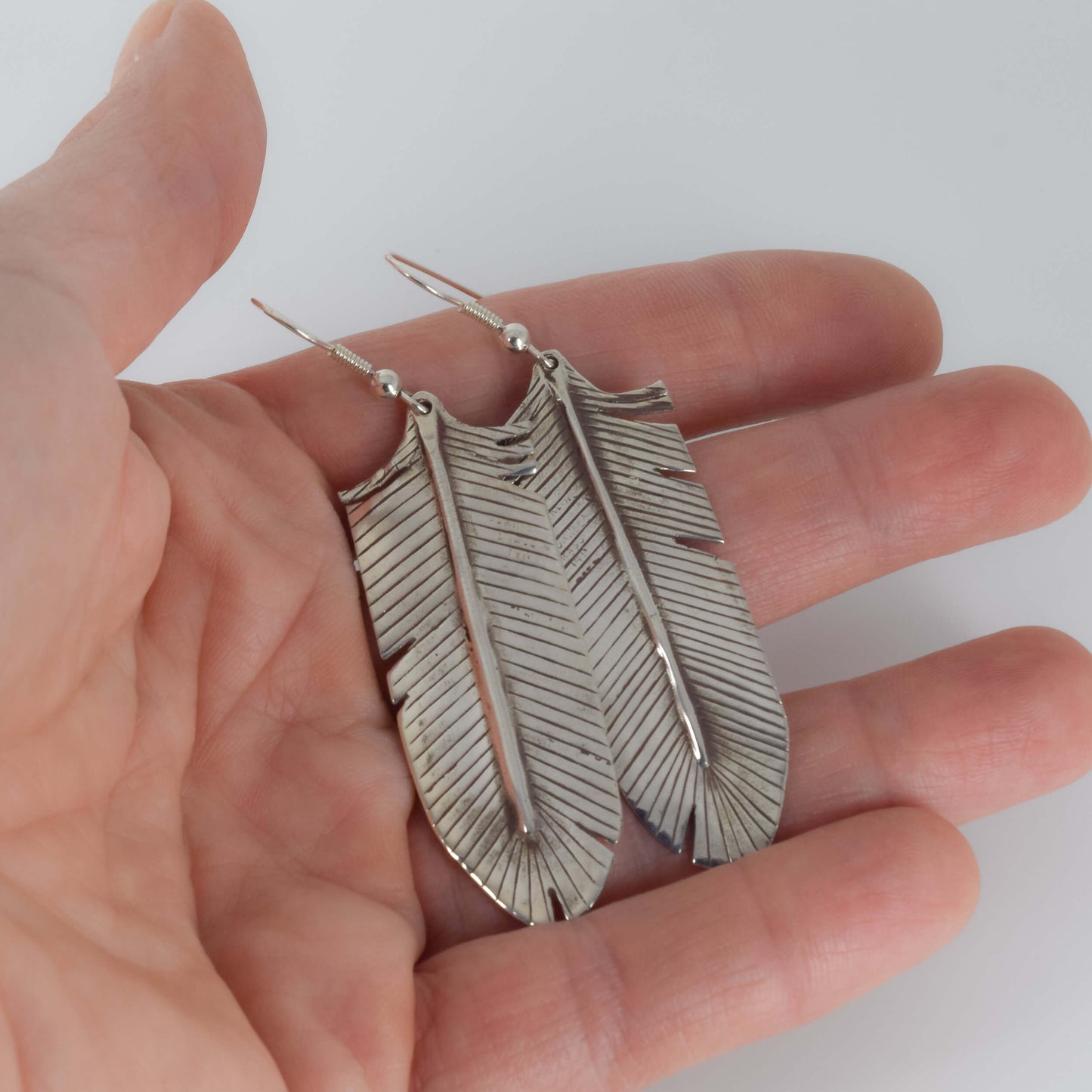 Long Feather Earrings in Sterling Silver Held in Hand for Scale - Jane Voorhees