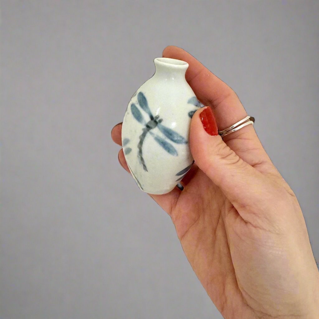 Mini Bottle with blue dragonflies held in hand for scale