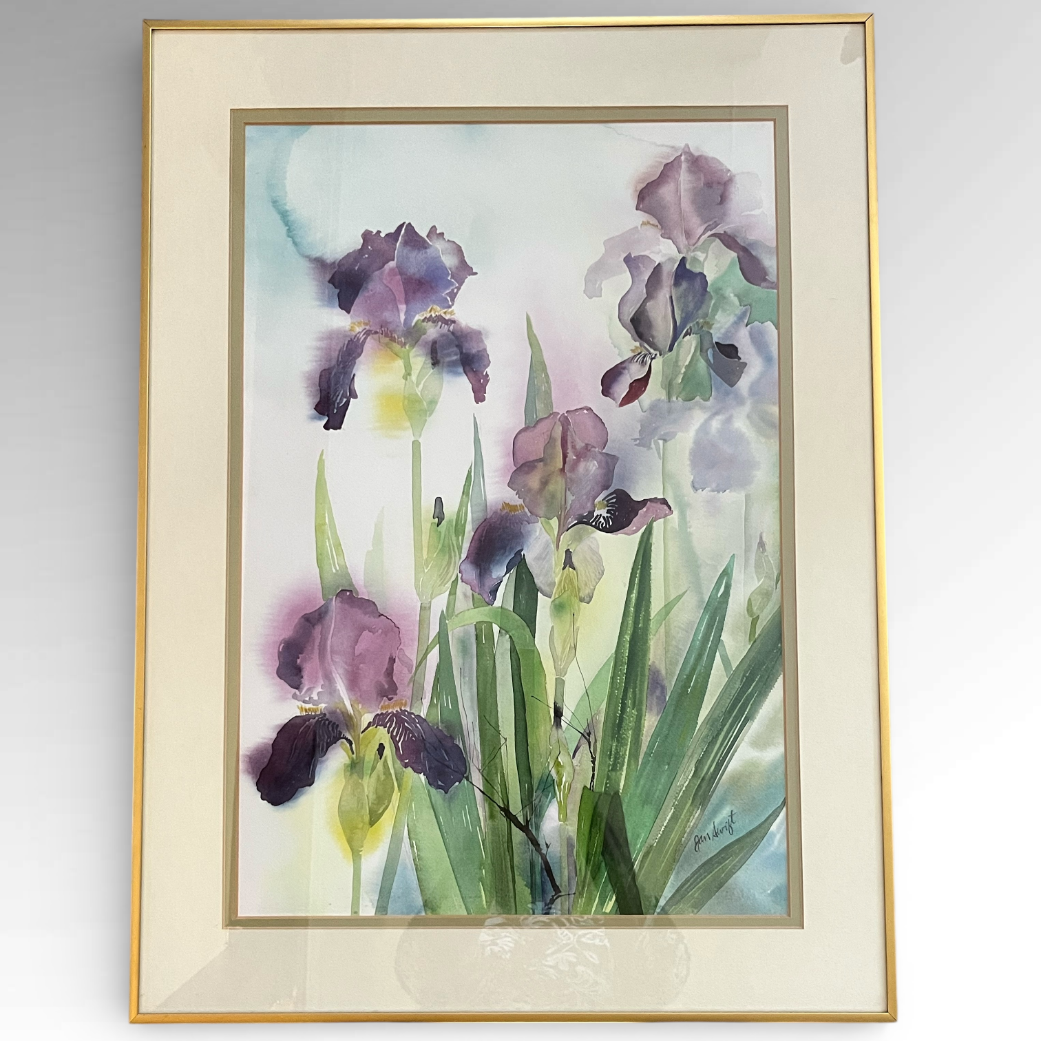 Framed watercolor painting of purple irises on a gray background