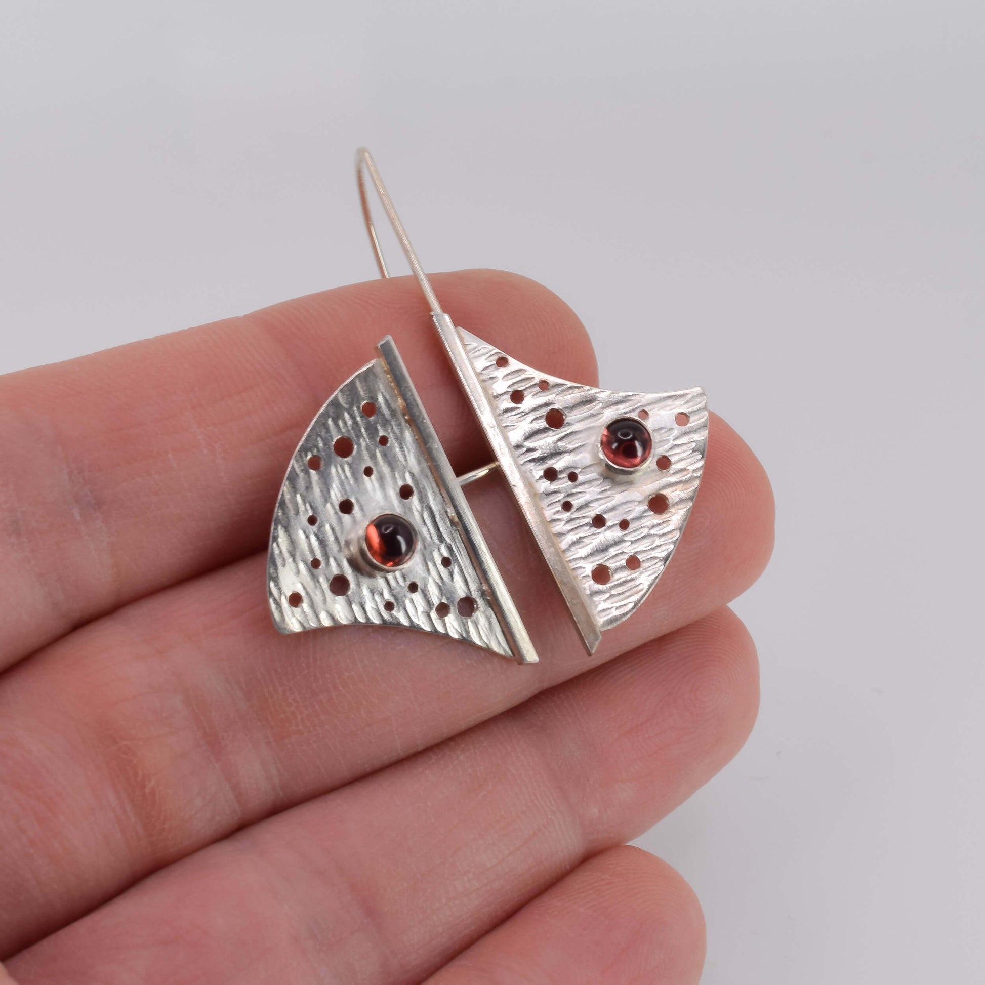 Sterling Silver Geometric Garnet Earrings shown in hand for scale - Jeanine Erickson