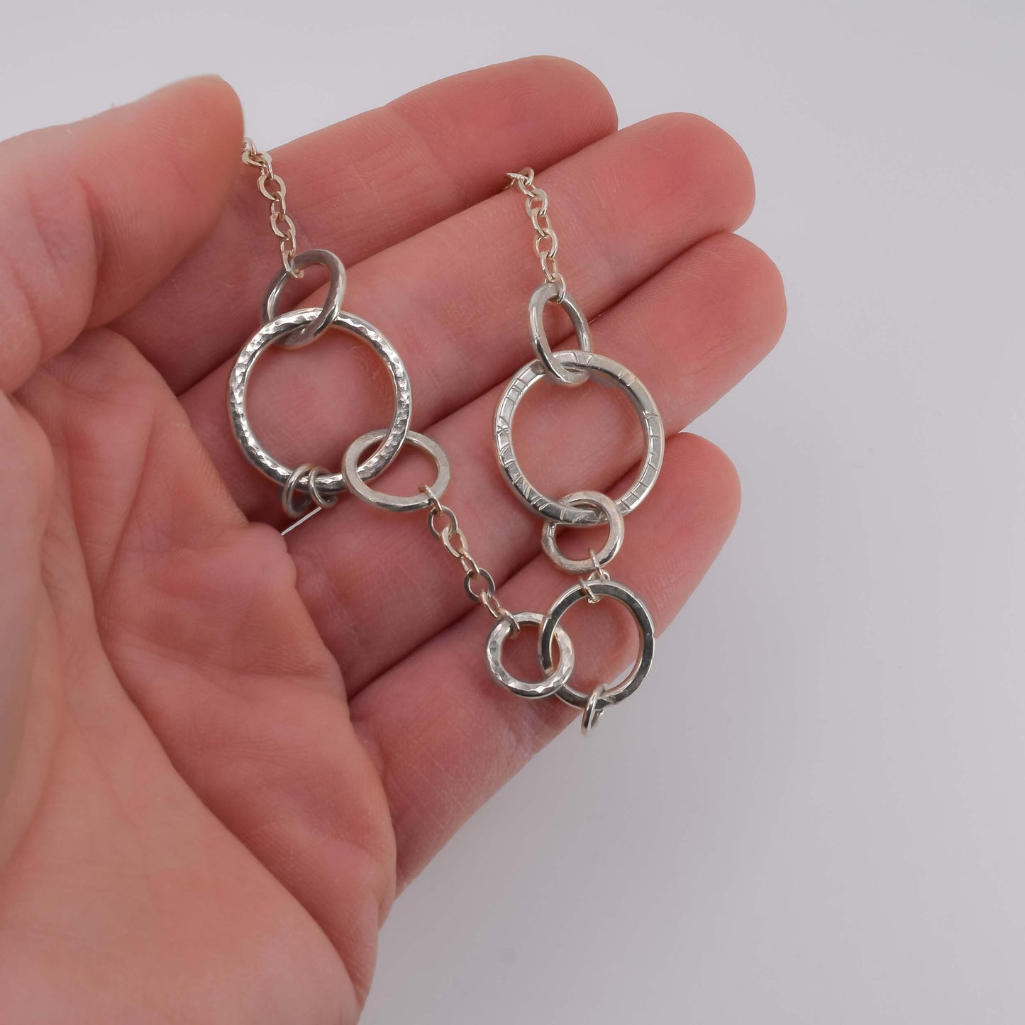 Sterling Silver Geometric Necklace held in hand for scale - Jeanine Erickson